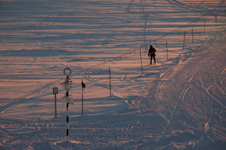 Chris skis towards the Halley sign as the sun sets