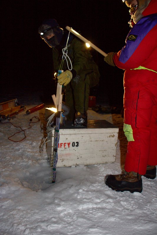 Installing a 2m long string of thermistors to measure ice growth and heat flows. (Andy)